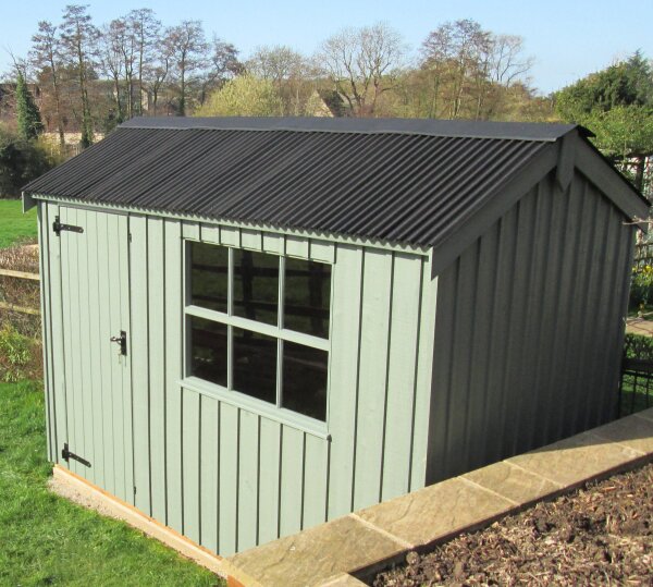 Timber garden shed with vertical cladding, double doors, windows and a dark corrugated pitched roof.